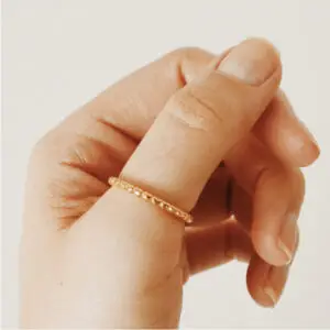 A person holding their hand out to the camera.