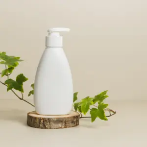 A white bottle sitting on top of a wooden block.