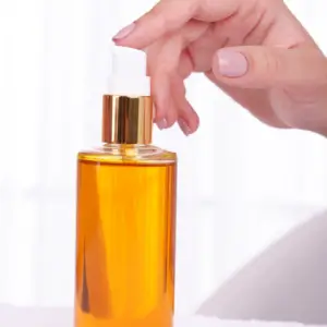 Hand reaching for a pump bottle.