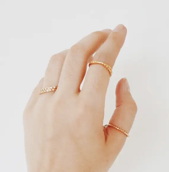 A hand with two rings on it