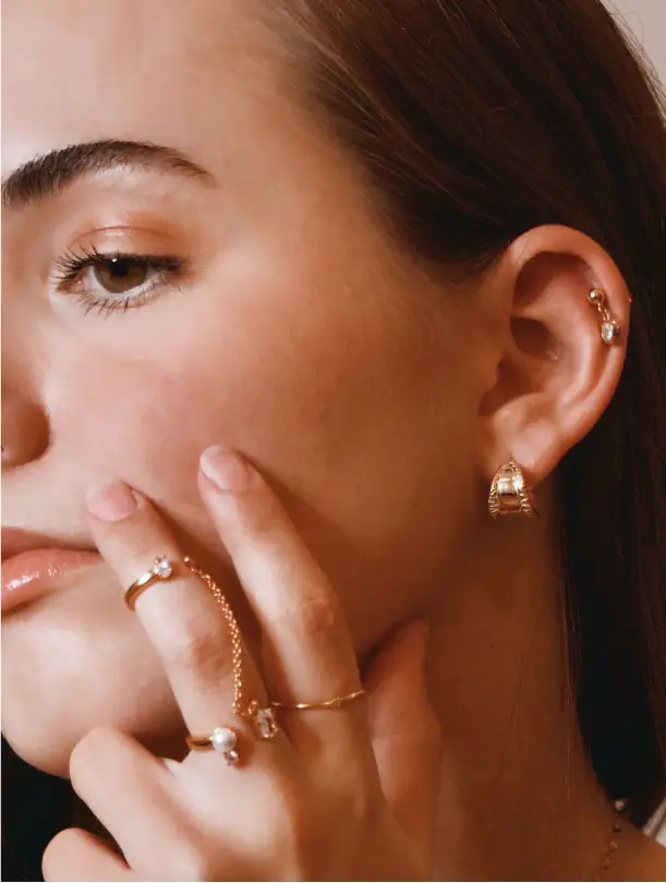 A woman with her hand on her face.