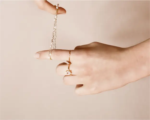 A person holding onto a chain with two rings on it