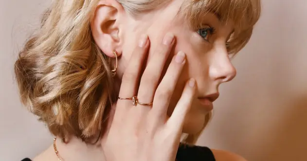 A woman with her hand on the side of her face.