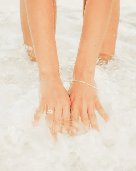 A woman 's feet and hands are shown in the snow.